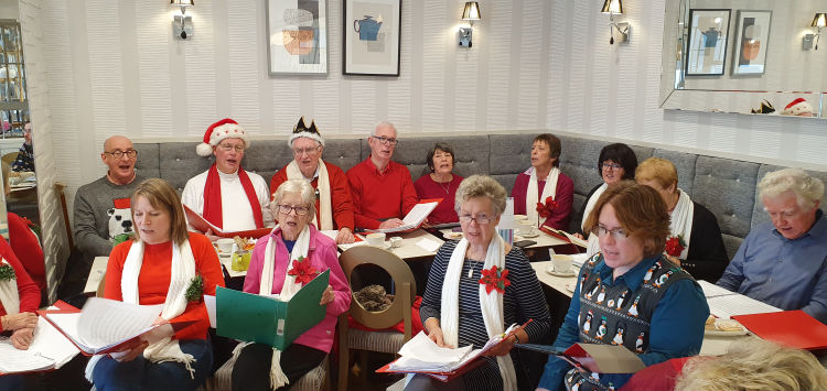 Singing carols at Camp Hopson's Angelina's Cafe